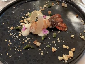 Spiny lobster with almond mousse and crumble, garlic-infused ring and fried asparagus tips